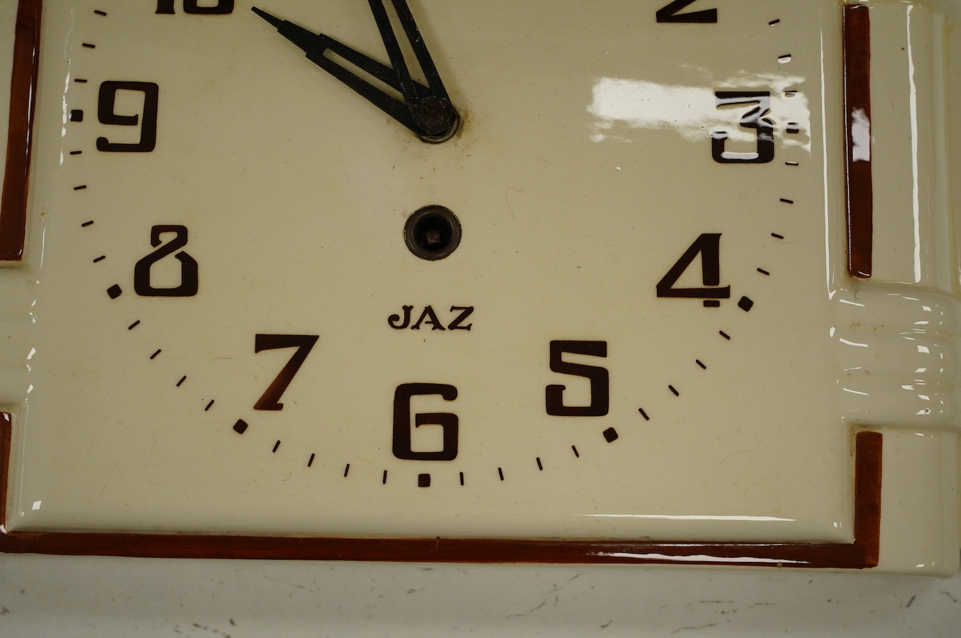 An Art Deco Jaz porcelain wall clock, 23cm high. Condition - fair, surface rust to the case of the movement, etc.